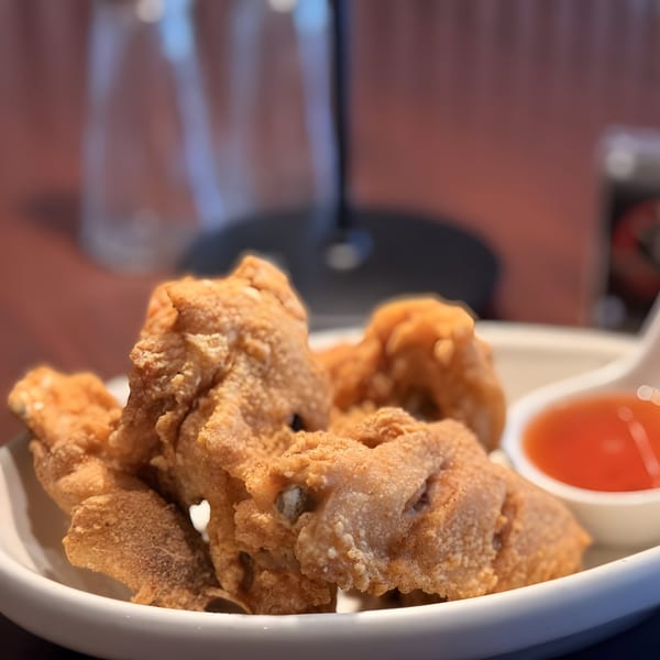Crispy fried Thai chicken skin served with a side of sweet chili dipping sauce.