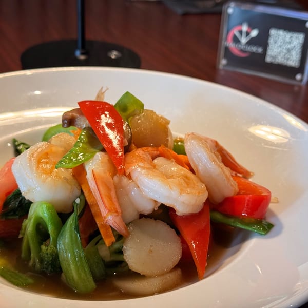 Thai O'Clock's stir-fried shrimp, scallops, and colorful vegetables in a savory sauce.